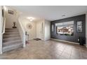 Inviting foyer featuring neutral tile floors, a staircase and large window for natural light at 77 W Diamond Trl, San Tan Valley, AZ 85143