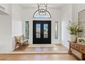 Bright foyer featuring a black, arched doorway, and a charming bench against white walls at 8336 E Calle De Alegria --, Scottsdale, AZ 85255