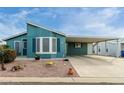 Single-Gathering home showing a covered carport, xeriscaped yard, and freshly painted exterior at 8500 E Southern Ave # 488, Mesa, AZ 85209