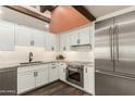 Modern kitchen featuring stainless steel appliances, white cabinets, and dark hardware at 8502 E Cave Creek Rd # 53, Carefree, AZ 85377