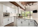 Well-lit kitchen featuring stainless steel appliances, and a breakfast bar overlooking the landscaped backyard at 8502 E Cave Creek Rd # 53, Carefree, AZ 85377