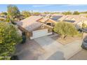 Aerial view of a single Gathering home showcasing the driveway, garage, and solar panels at 8630 W Apache St, Tolleson, AZ 85353