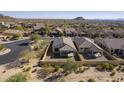 Aerial view of a desert neighborhood featuring homes with tile roofs and desert landscaping at 8634 E Kael Cir, Mesa, AZ 85207