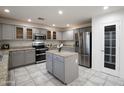 Spacious kitchen with stainless steel appliances, granite countertops, and ample cabinet storage at 9144 W Quail Ave, Peoria, AZ 85382