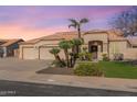 Inviting single-story home featuring a three-car garage, well-manicured lawn, desert landscaping, and a tile roof at 9544 E Irwin Ave, Mesa, AZ 85209