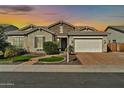 Charming single-story home features stone accents, a two-car garage, and well-maintained landscaping at 9388 W Cashman Dr, Peoria, AZ 85383