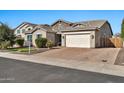 Charming single-story home features stone accents, a two-car garage, and well-maintained landscaping at 9388 W Cashman Dr, Peoria, AZ 85383