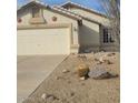 Front exterior of a single-story house featuring desert landscaping and a two-car garage at 10622 W Mohawk Ln, Peoria, AZ 85382