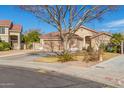 Charming single-story home with a tile roof, mature tree, and a two-car garage on a well-maintained lot at 1182 E Jasper Dr, Gilbert, AZ 85296