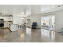 Bright living area featuring tile flooring, modern paint, and access to the backyard patio at 12054 W Aster W Dr, El Mirage, AZ 85335