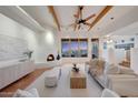 Bright living room with fireplace, exposed beams, and views of the scenery at 15601 E El Lago Blvd, Fountain Hills, AZ 85268
