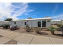 Well-maintained single-story home with desert landscaping, creating a charming and inviting facade at 17200 W Bell Rd # 2162, Surprise, AZ 85374