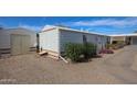 Side view of home, showcasing the storage shed and well-kept grounds at 17200 W Bell Rd # 2162, Surprise, AZ 85374