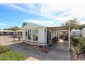 Single-story home with a covered patio and outdoor seating, perfect for enjoying outdoor living at 17200 W Bell Rd # 2162, Surprise, AZ 85374