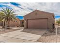Charming single-story home with a two-car garage and xeriscaping in the front yard at 17815 W Calistoga Dr, Surprise, AZ 85387