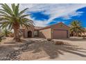 Charming single-story home featuring a desert landscape, a two car garage, and a tile roof at 17815 W Calistoga Dr, Surprise, AZ 85387