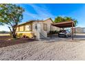 Ranch style home featuring a desert landscape and covered parking at 19412 W Clarendon Ave, Litchfield Park, AZ 85340