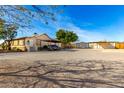 Long ranch style home with gravel driveway and covered parking at 19412 W Clarendon Ave, Litchfield Park, AZ 85340