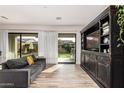 Bright living room featuring sliding glass doors to the backyard and a built-in entertainment center at 2065 N Red Clf, Mesa, AZ 85207