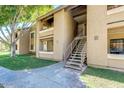 A close view of the condo's exterior with stairs leading up to the units at 2146 W Isabella Ave # 215, Mesa, AZ 85202