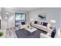 Bright living room with modern furniture and a sliding glass door to a balcony at 2146 W Isabella Ave # 215, Mesa, AZ 85202