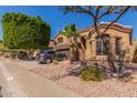 Charming home featuring manicured landscaping, a spacious driveway, and a three-car garage at 408 E Silverwood Dr, Phoenix, AZ 85048