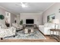 Well-lit living room featuring a cozy seating arrangement, fireplace, and wood laminate flooring at 502 E Mountain View Rd, San Tan Valley, AZ 85143