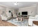 Bright living room with stylish furniture, modern entertainment center and hardwood floors at 502 E Mountain View Rd, San Tan Valley, AZ 85143