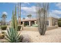 Well-maintained desert front yard with a variety of cacti and succulents at 5420 E Acoma Dr, Scottsdale, AZ 85254