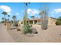 Southwestern style home with xeriscaping including native plants and palm trees at 5420 E Acoma Dr, Scottsdale, AZ 85254