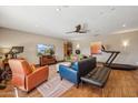 Bright living room with wood floors, comfortable seating, and a ceiling fan at 5420 E Acoma Dr, Scottsdale, AZ 85254