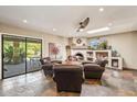 Cozy sitting room with fireplace, skylight, and sliding doors to the back patio at 5420 E Acoma Dr, Scottsdale, AZ 85254