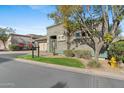 Well-kept yard of this home, showcasing stone details, green lawn, and mature trees at 6426 N 27Th St, Phoenix, AZ 85016