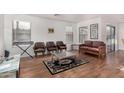 Bright living room with wood floors, large windows, and neutral color palette at 665 E Winchester Way, Chandler, AZ 85286