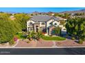 Beautiful two-story home with lush landscaping and a well-manicured lawn, showcasing its curb appeal at 6960 E Ivyglen St, Mesa, AZ 85207