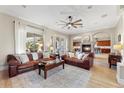 Spacious living area with a fireplace, hardwood floors, and access to the outdoor patio, great for entertaining at 6960 E Ivyglen St, Mesa, AZ 85207