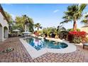 Inviting pool surrounded by lush greenery, a patio area, and comfortable seating for outdoor relaxation at 6960 E Ivyglen St, Mesa, AZ 85207