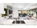 Stylish living area with marble countertops, a fireplace, and a seamless indoor-outdoor flow with a balcony at 7161 E Rancho Vista Dr # 1011, Scottsdale, AZ 85251