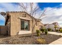 Side exterior shot of a single-story home, showcasing the yard and window at 7533 S Woodchute Dr, Gold Canyon, AZ 85118