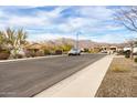 Neighborhood street view with mountain views in the background at 7533 S Woodchute Dr, Gold Canyon, AZ 85118