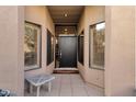 Inviting front entrance with sidelight windows and a sleek black door at 7740 E Gainey Ranch Rd # 36, Scottsdale, AZ 85258