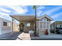Charming home featuring a carport, palm trees, and desert landscaping at 834 S Beryl Dr, Apache Junction, AZ 85119