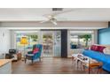 Bright living area featuring vinyl floors, ample windows, and a sliding glass door at 10303 W Desert Forest N Cir, Sun City, AZ 85351