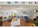 Open-concept living room and dining area with neutral-colored walls and vinyl flooring at 10303 W Desert Forest N Cir, Sun City, AZ 85351