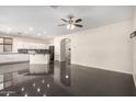 Open-concept layout with black tile flooring, and white cabinetry at 13408 W Mauna Loa Ln, Surprise, AZ 85379