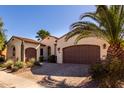 Stunning single-story home with desert landscaping, a paved driveway, and a two-car garage at 1681 E Maygrass Ln, Queen Creek, AZ 85140