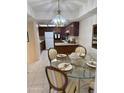 Eat-in kitchen with glass dining table and pendant lighting at 17404 N 99Th Ave # 136, Sun City, AZ 85373