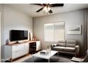 Bright living room featuring a modern desk, stylish seating and a large window at 18474 N Celis St, Maricopa, AZ 85138