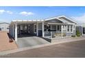 Single-story home with covered parking, a cozy front porch, and attractive two-tone color scheme at 2206 S Ellsworth Rd # 157B, Mesa, AZ 85209