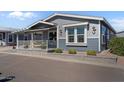 Close-up of a charming home, showcasing the well-kept front yard and cozy covered porch at 2206 S Ellsworth Rd # 157B, Mesa, AZ 85209